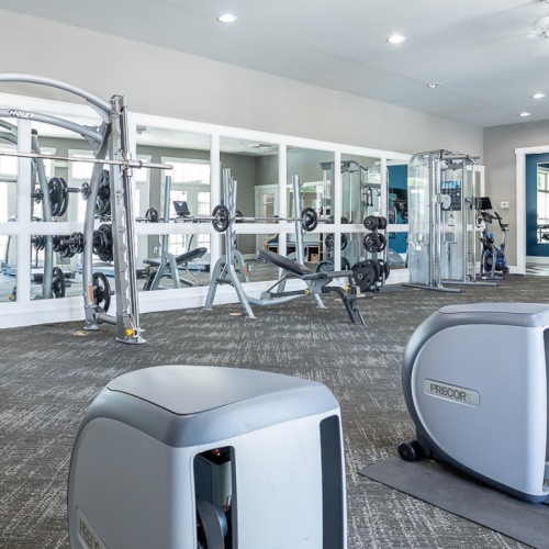 Reach your health goals in our fitness center Fitness center with elliptical equipment