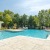 Pool and sundeck surrounded by trees