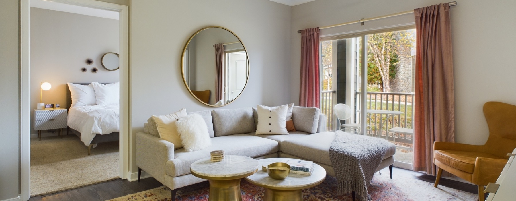 living room with couch, mirror, and a table
