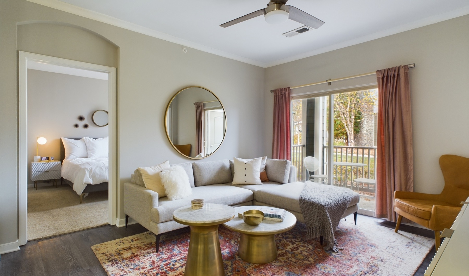 Find your home in Noblesville at Prairie Lakes Apartments living room with couch, mirror, and a table