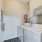 bright laundry room with side-by-side washer/dryer units