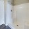 walk-in shower with curtain rod in bathroom
